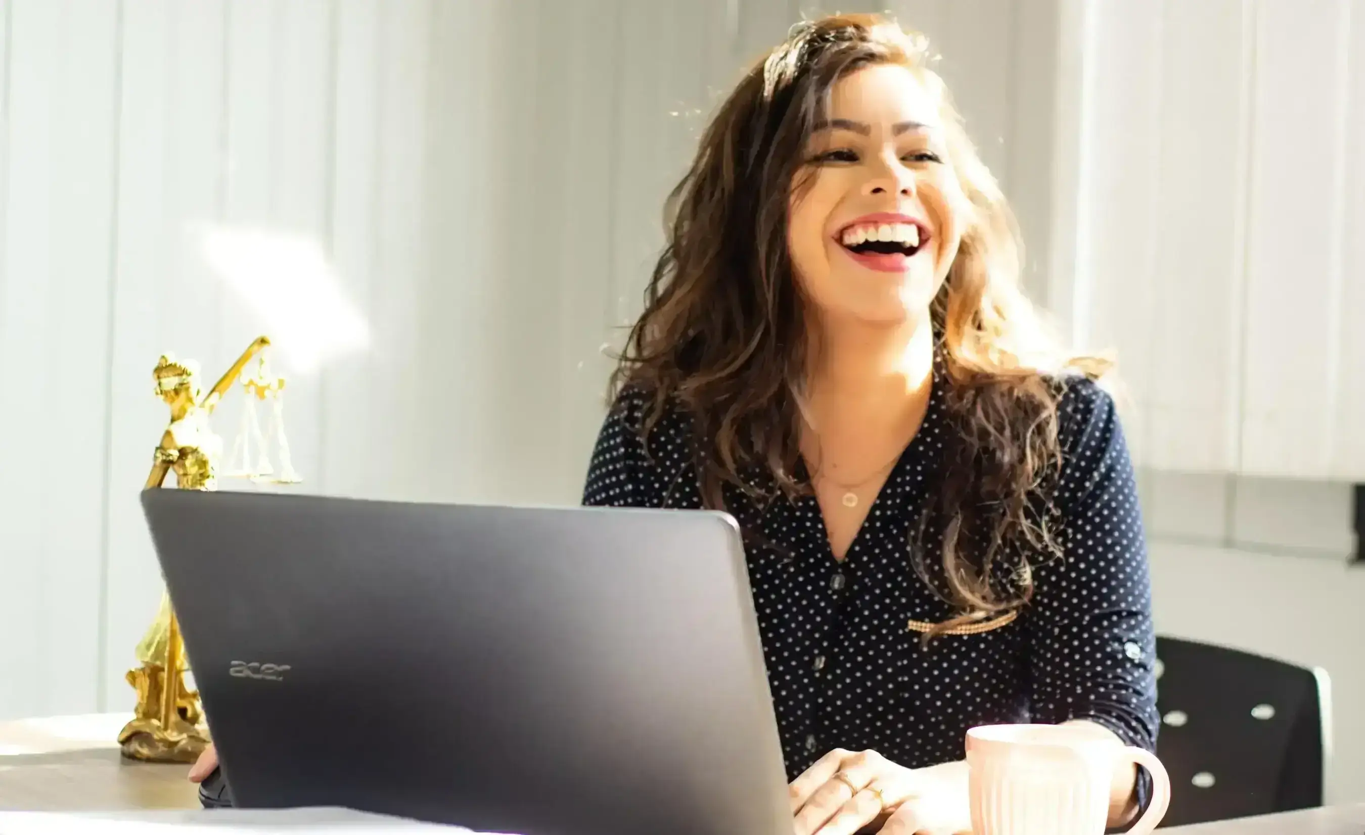 Portrait of a young woman at the office with a very big smile